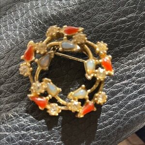 vintage gold-tone wreath brooch with faux opal, red stones, and rhinestones